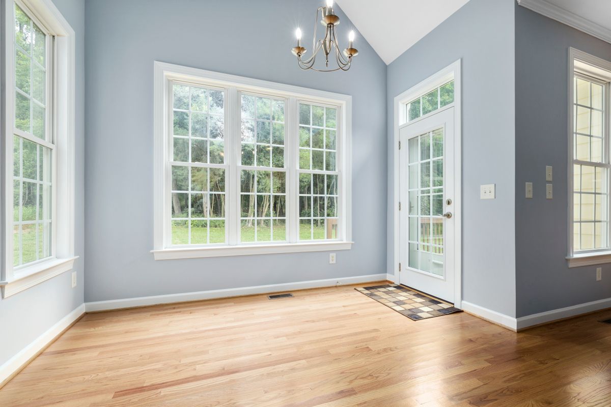 Bright room with multiple windows and a glass exterior door