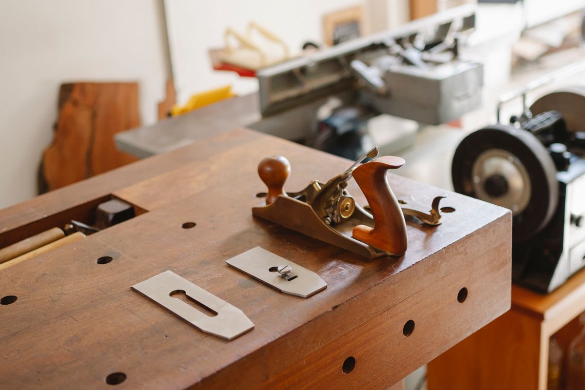 Carpentry hand plane and tools arranged on a workbench