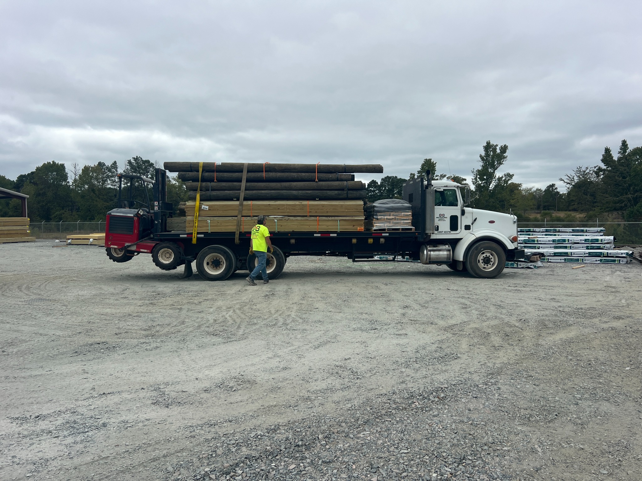 Jason with a Best Builders Supply delivery truck loaded with building materials
