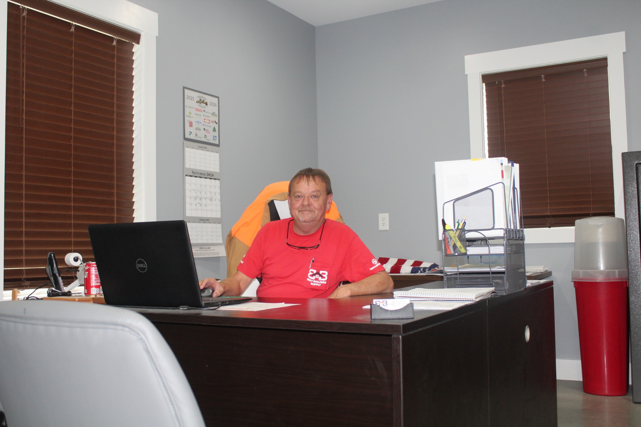 Best Builders Supply owner working at his office desk
