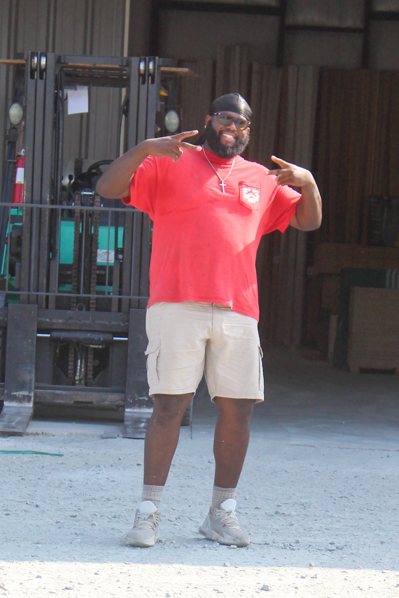 Alex smiling in a red company shirt at Best Builders Supply