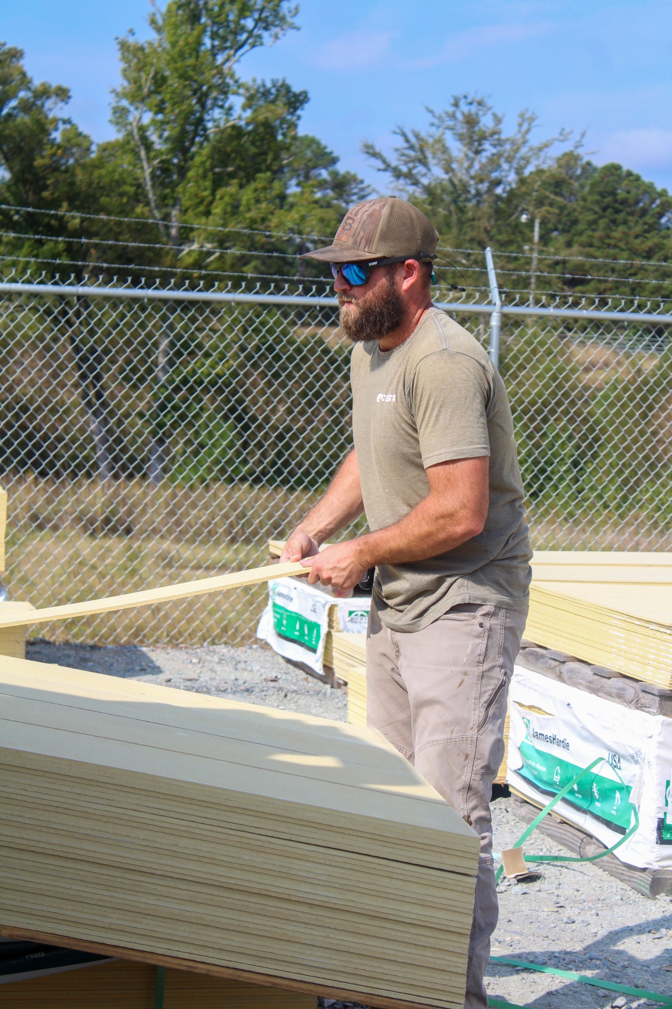 Dallas Hollomon handling lumber in the Best Builders Supply yard